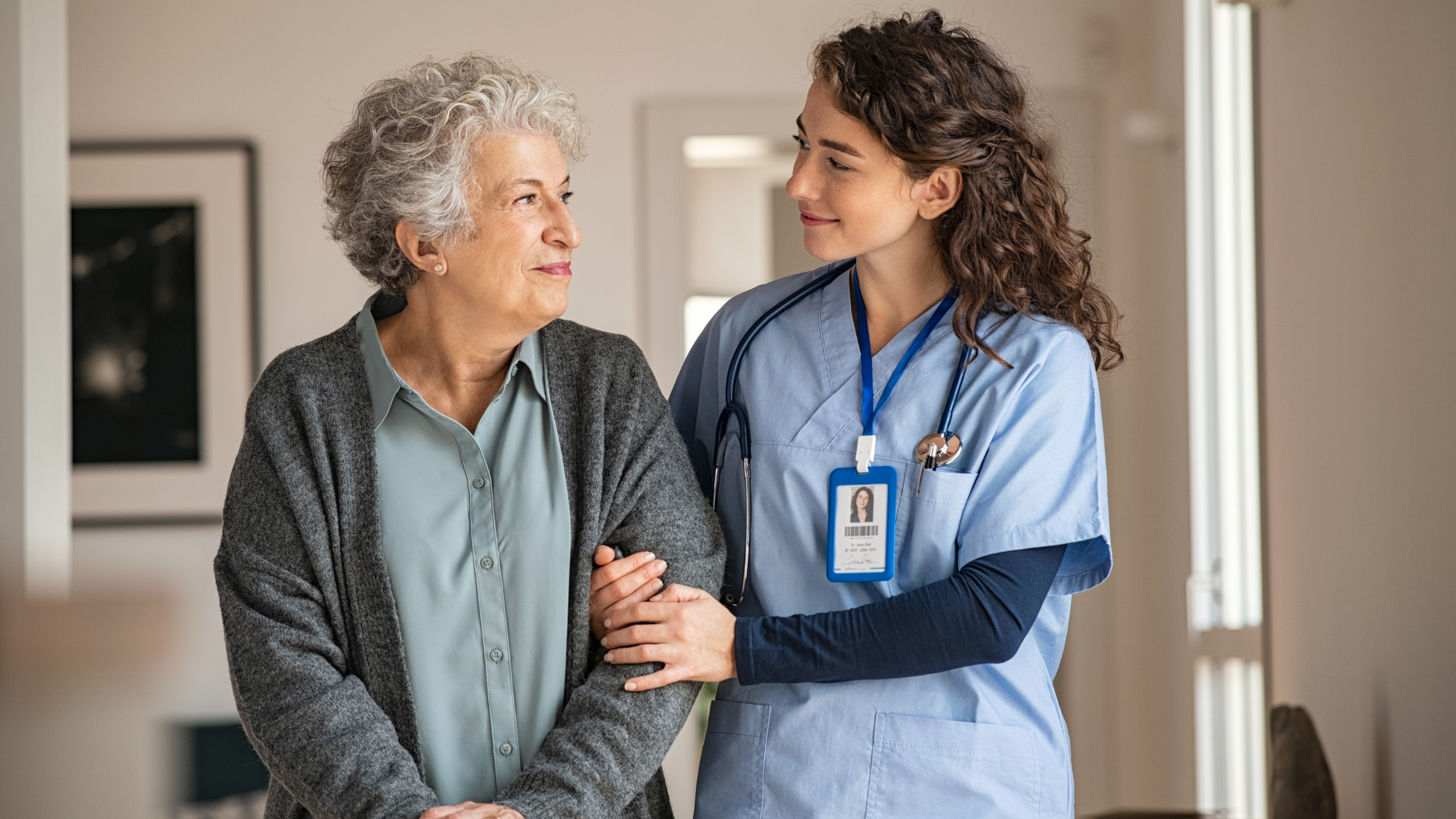 orderly in scrubs hands sitting senior woman a glass of water orderly in scrubs hands sitting senior woman a glass of water