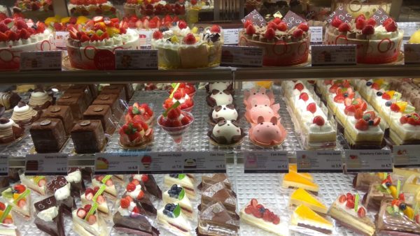 A bakery-style display of cake, pie, and other sweets