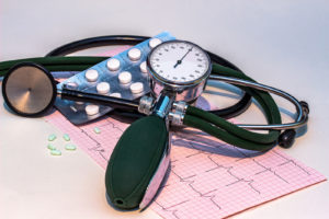 A stethoscope, blood pressure checking device, and a pack of pill tablets